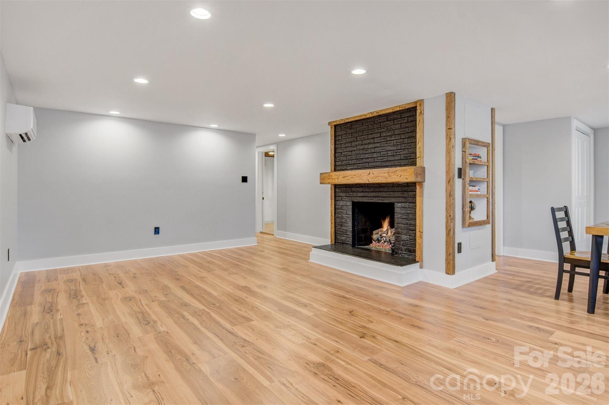 1206 9th Street Northwest Hickory, NC 28601 - Photo 25 of 40 a view of empty room with fireplace and wooden floor