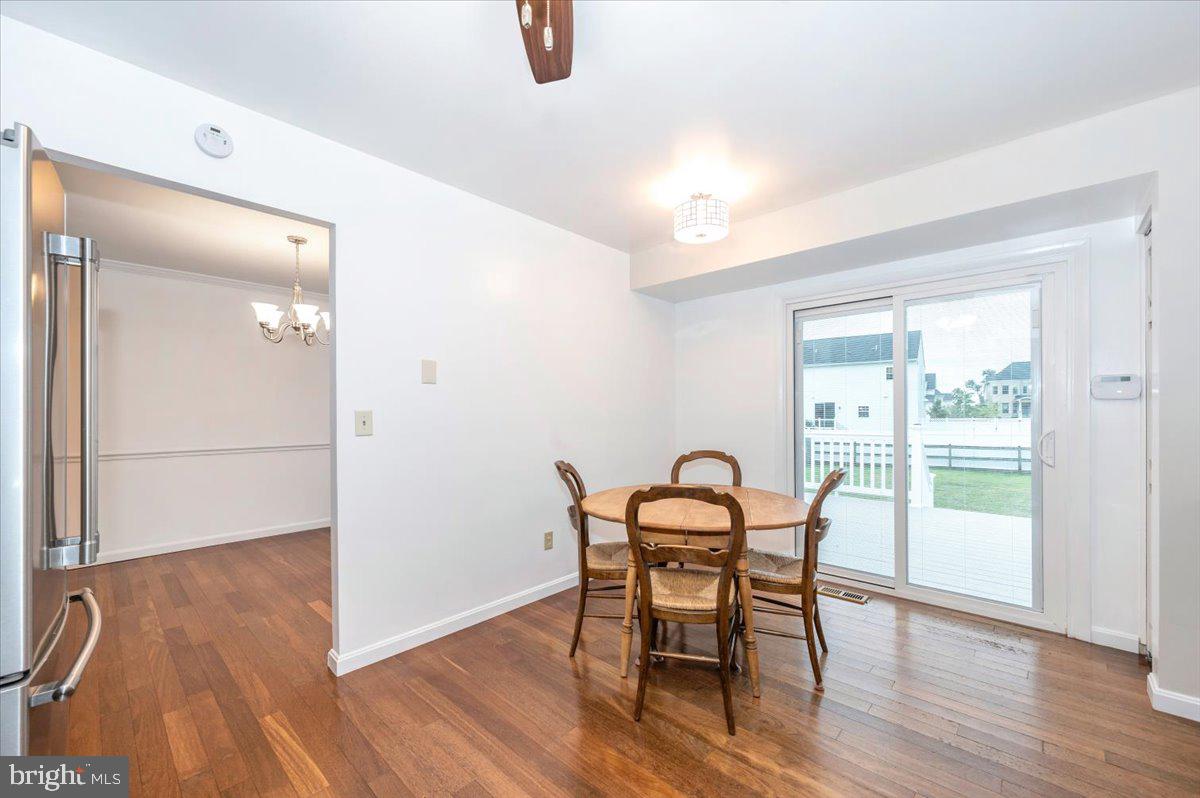 19924 Westerly Avenue Poolesville, MD 20837 - Photo 15 of 80 a dining room with furniture and wooden floor