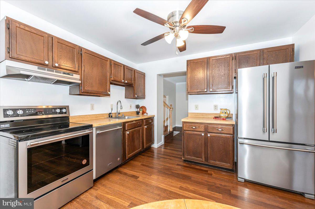 19924 Westerly Avenue Poolesville, MD 20837 - Photo 18 of 80 a kitchen with stainless steel appliances granite countertop a refrigerator stove top oven a sink and dishwasher