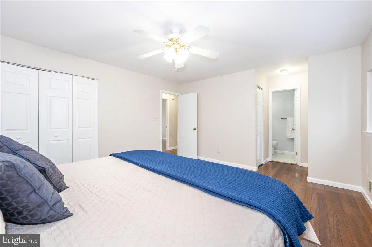 19924 Westerly Avenue Poolesville, MD 20837 - Photo 26 of 80 a bedroom with a bed and a chandelier