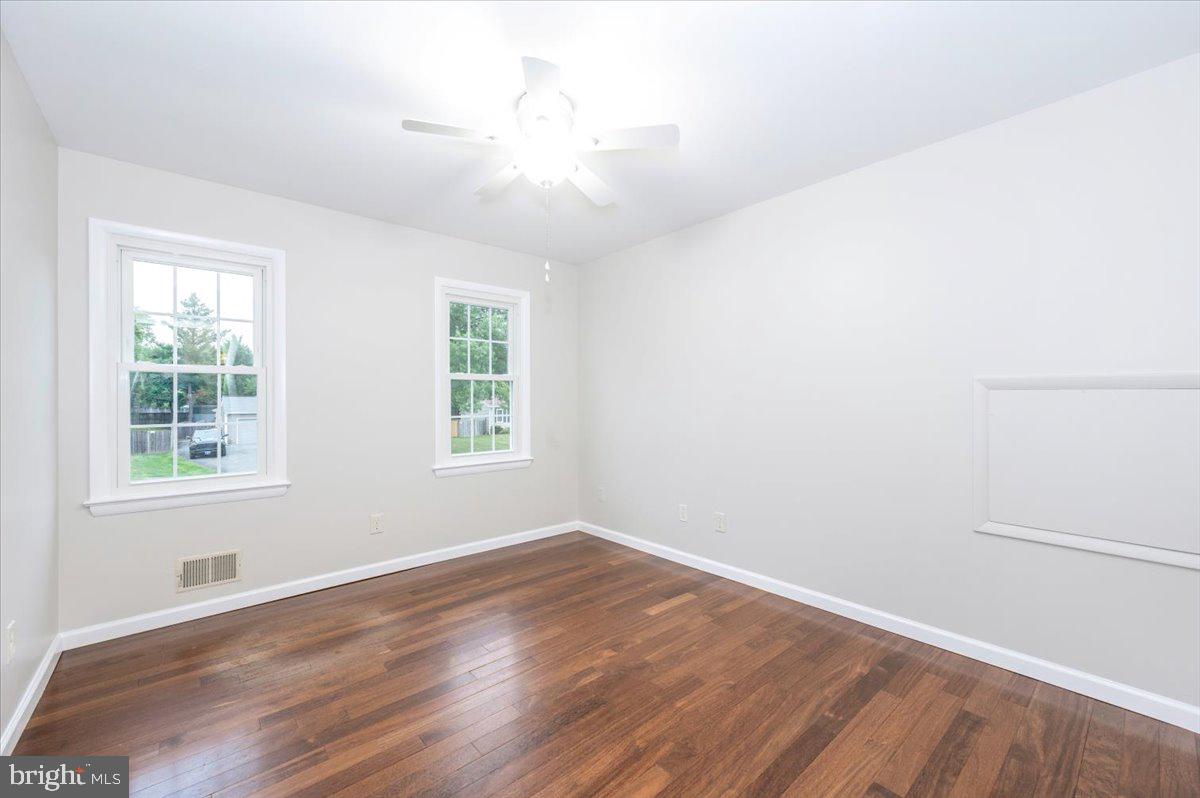 19924 Westerly Avenue Poolesville, MD 20837 - Photo 27 of 80 an empty room with wooden floor and windows