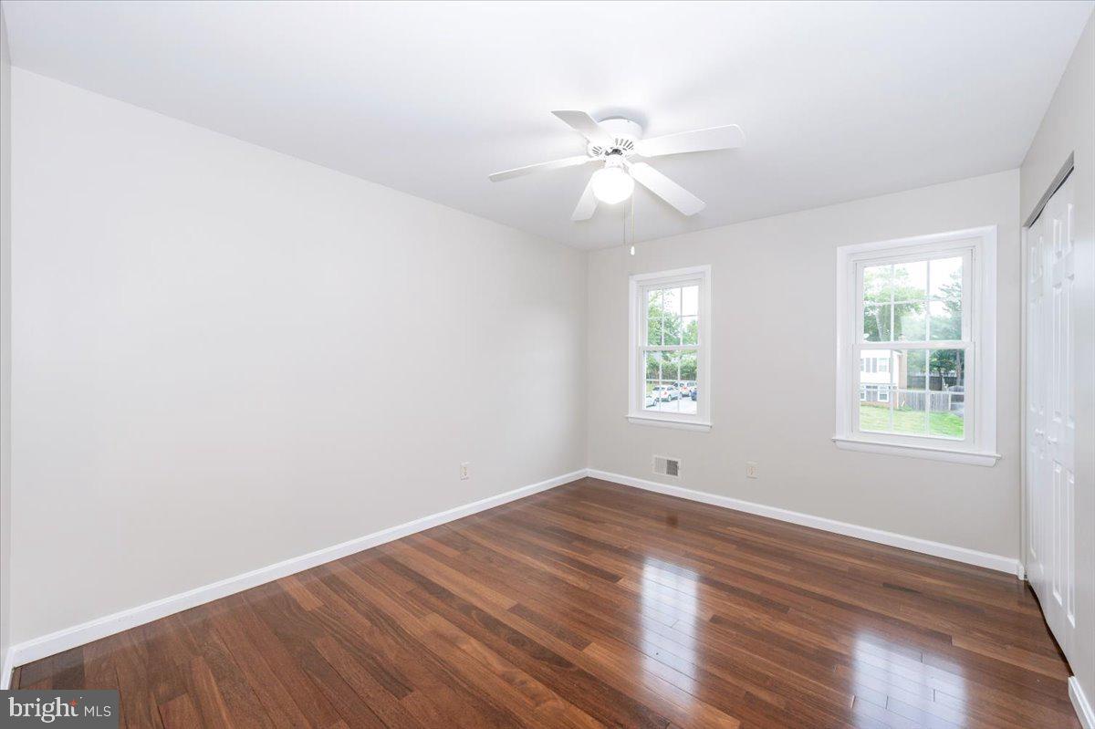19924 Westerly Avenue Poolesville, MD 20837 - Photo 30 of 80 a view of an empty room with wooden floor and a window