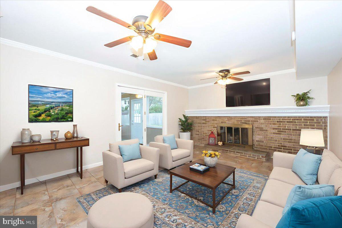 19924 Westerly Avenue Poolesville, MD 20837 - Photo 33 of 80 a living room with furniture a fireplace and a flat screen tv