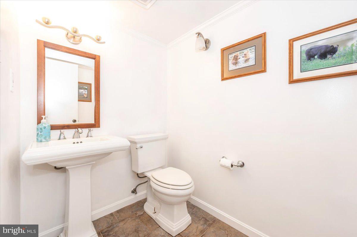 19924 Westerly Avenue Poolesville, MD 20837 - Photo 36 of 80 a bathroom with a toilet sink and mirror