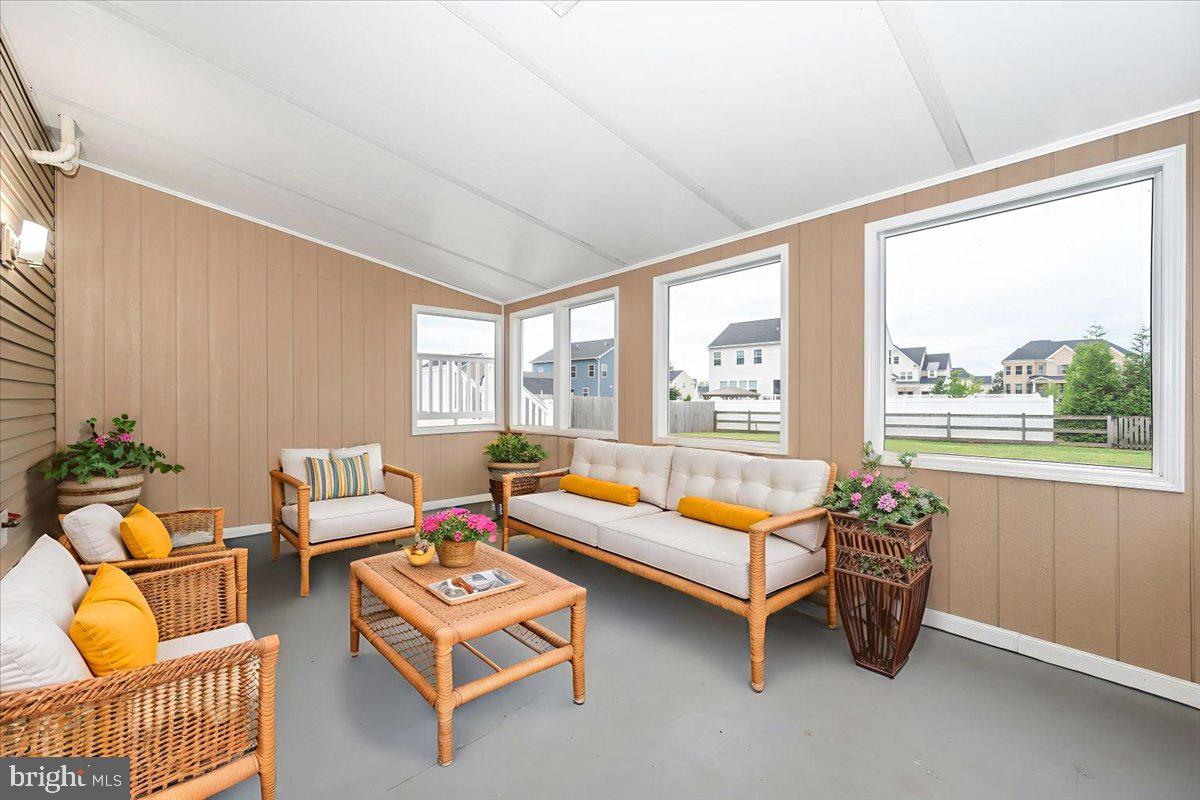 19924 Westerly Avenue Poolesville, MD 20837 - Photo 38 of 80 a living room with furniture and a floor to ceiling window