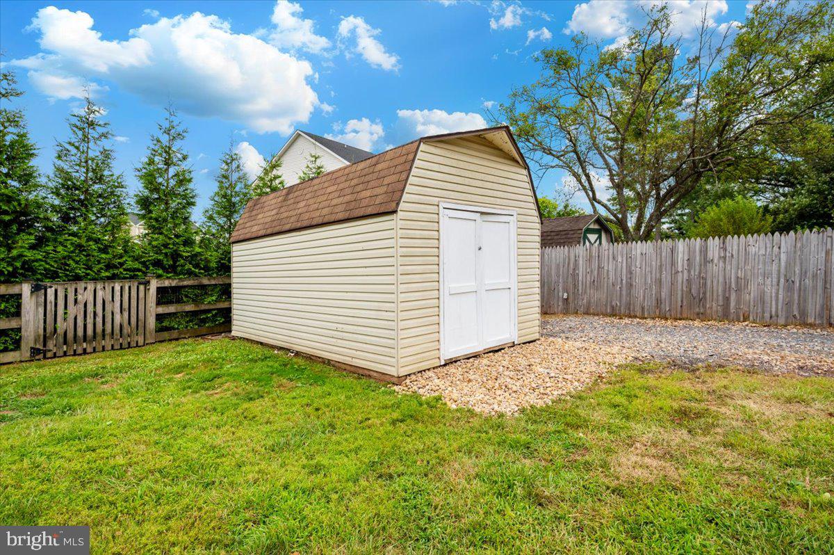 19924 Westerly Avenue Poolesville, MD 20837 - Photo 52 of 80 a view of a house with a small yard and wooden fence