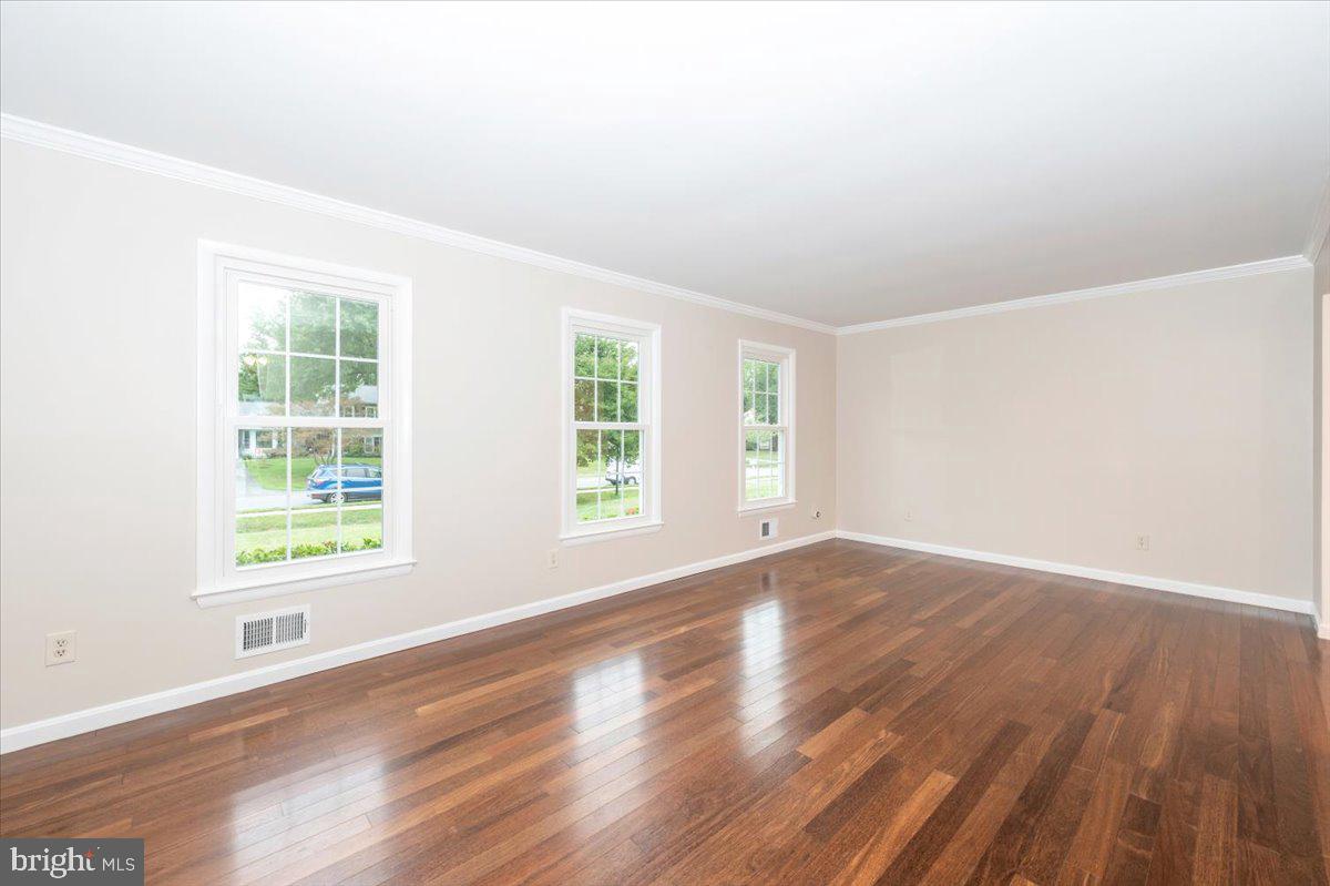 19924 Westerly Avenue Poolesville, MD 20837 - Photo 6 of 80 an empty room with wooden floor and windows