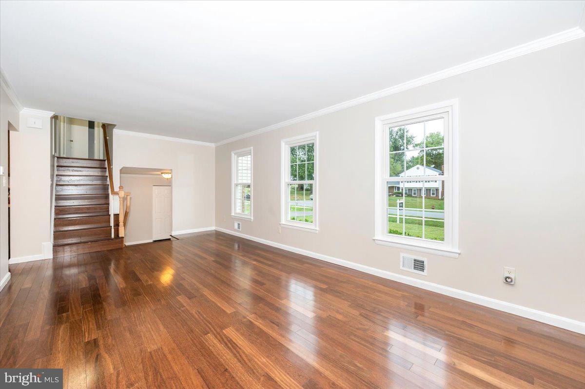 19924 Westerly Avenue Poolesville, MD 20837 - Photo 9 of 80 an empty room with wooden floor and windows