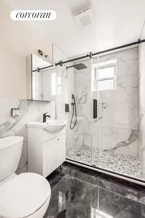 a bathroom with a sink toilet and shower