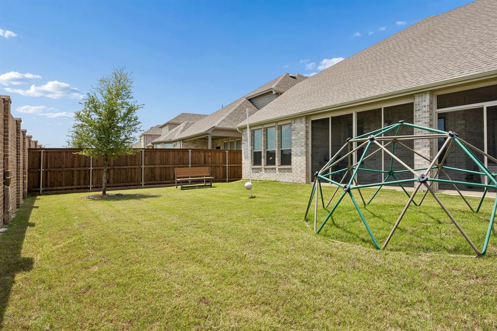 425 Breeds Hl Road Little Elm, TX 75068 - Photo 32 of 38 a view of a house with a backyard