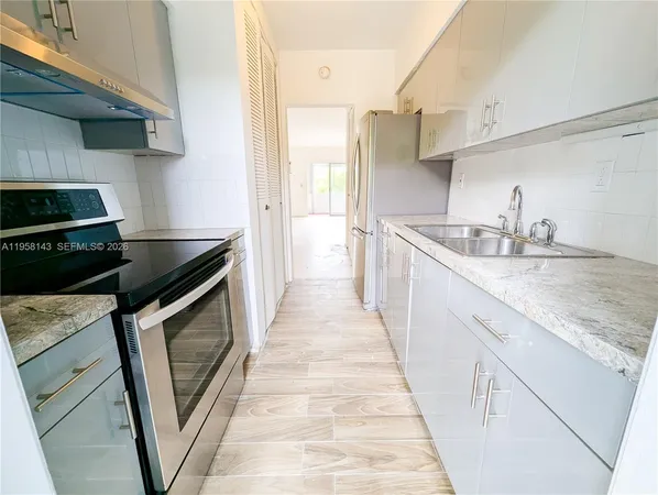 a kitchen with a sink stove and cabinets