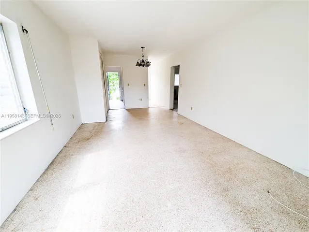 a view of a big room with closet and windows