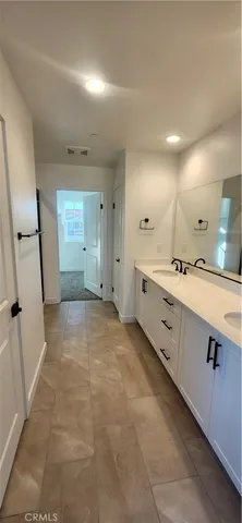 a large white kitchen with a sink