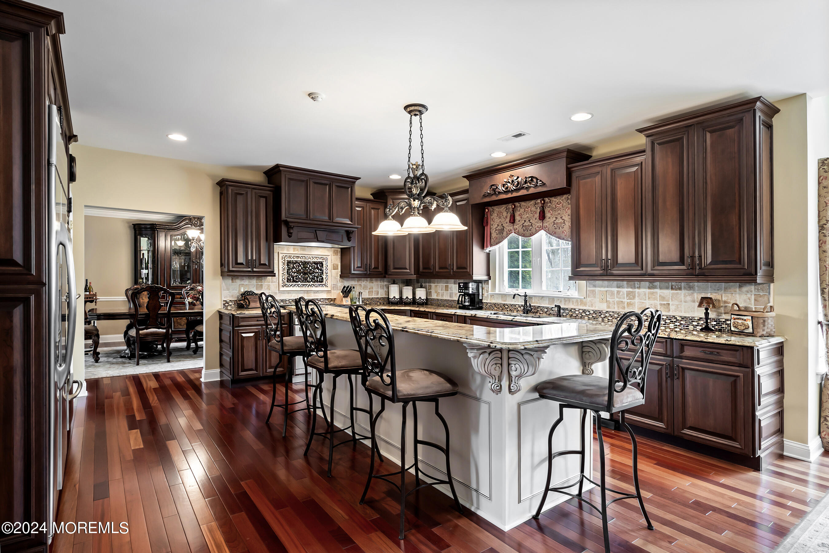 15 Summers Drive Jackson, NJ 08527 - Photo 26 of 83 a kitchen with stainless steel appliances granite countertop a stove top oven a sink dishwasher a dining table and chairs with wooden floor