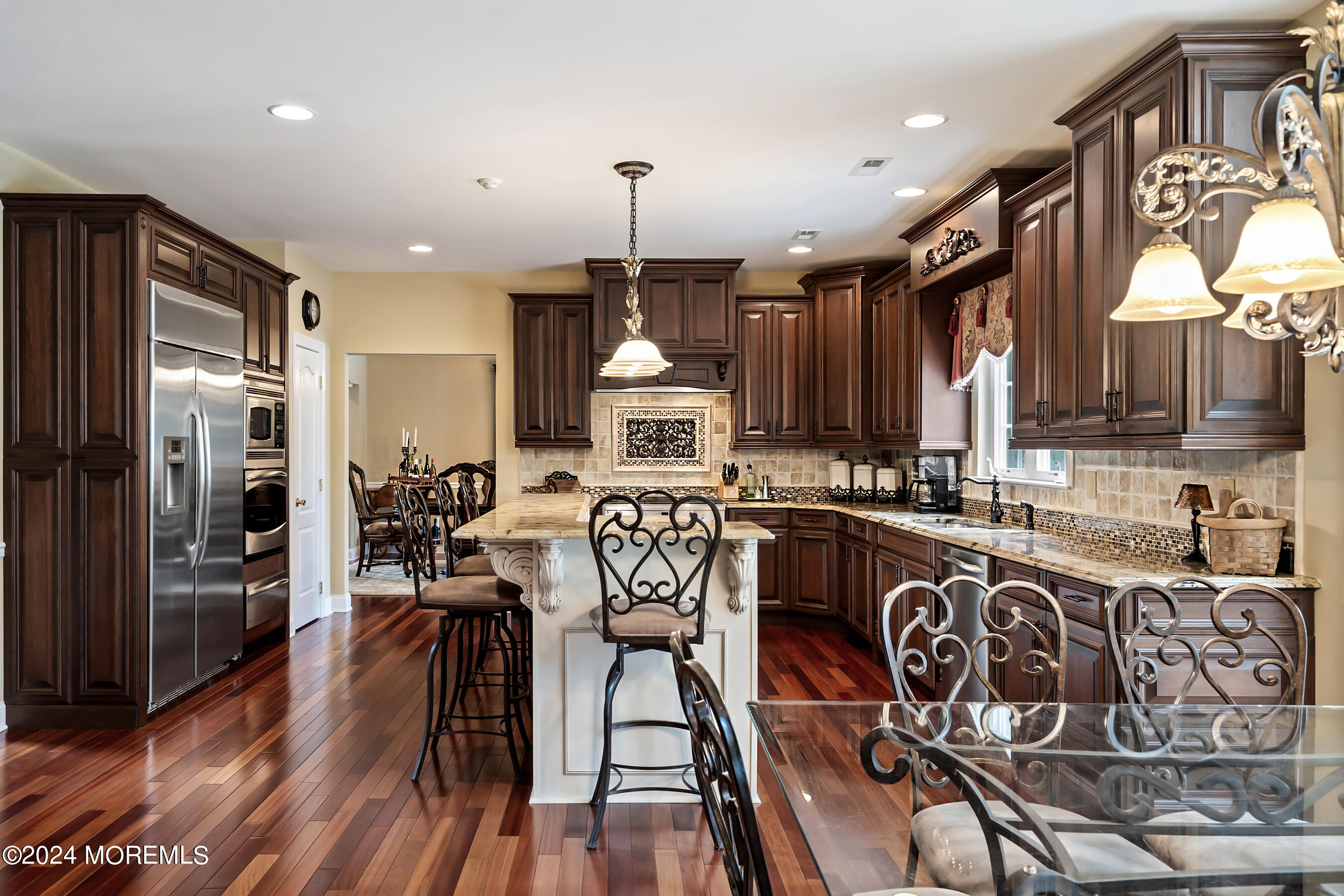 15 Summers Drive Jackson, NJ 08527 - Photo 27 of 83 a kitchen with stainless steel appliances granite countertop a refrigerator a sink dishwasher a stove and a dining table with wooden floor