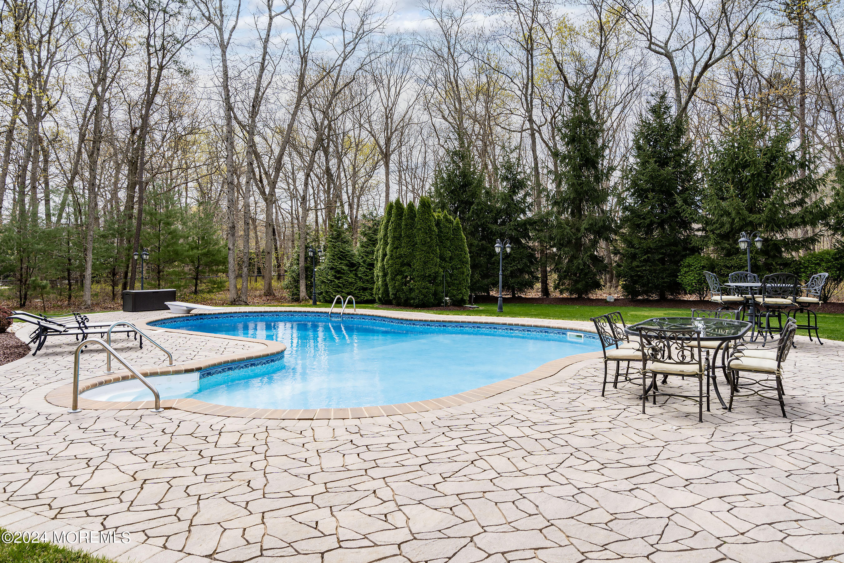 15 Summers Drive Jackson, NJ 08527 - Photo 70 of 83 a view of a swimming pool with chair and table under an umbrella