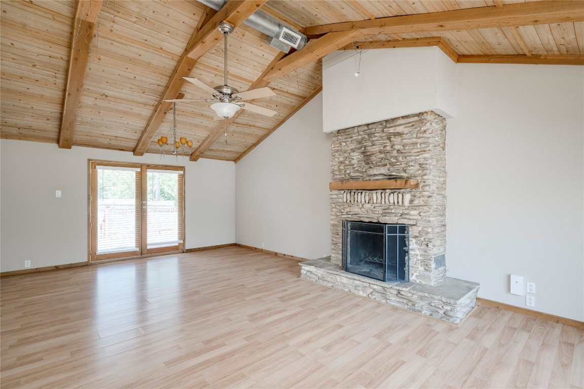 5602 Roosevelt Avenue Austin, TX 78756 - Photo 3 of 22 a view of an empty room with wooden floor fireplace and a window