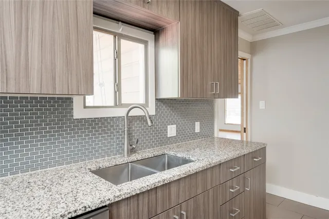 a kitchen with a sink cabinets and window