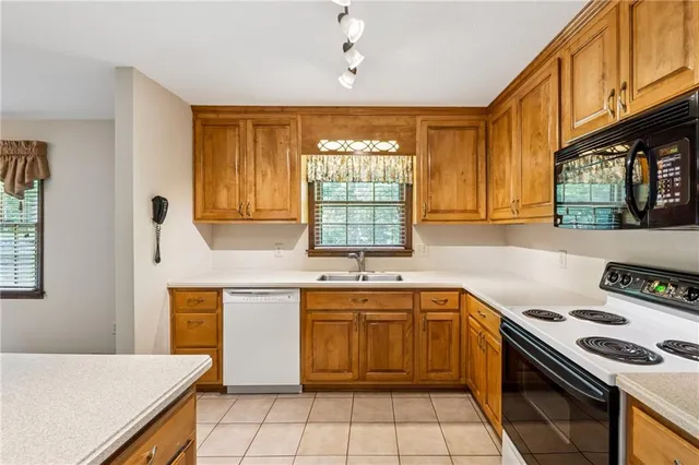 a kitchen with a sink stove top oven and cabinets