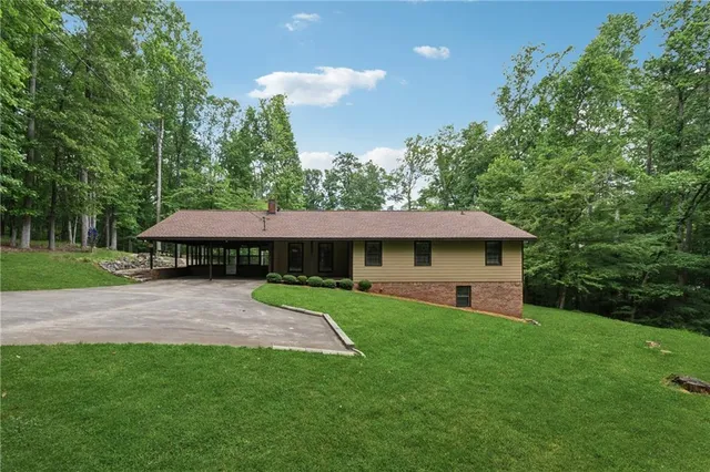 a view of a patio with a table and chairs under an umbrella