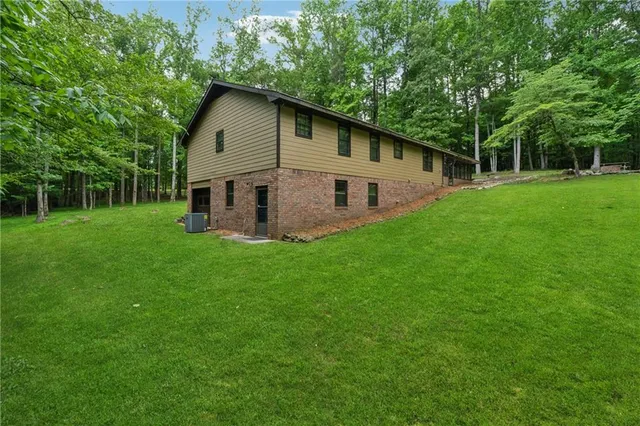 a front view of house with a garden and trees