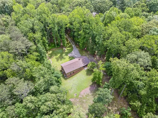 an aerial view of a house with a yard