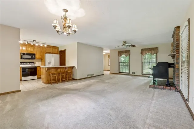 a view of a livingroom with furniture and a window