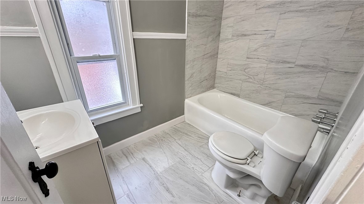 1914 Seneca Road Euclid, OH 44117 - Photo 10 of 30 Bathroom with baseboards, vanity, toilet, and marble finish floor