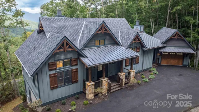 a aerial view of a house with a patio outdoor seating and yard