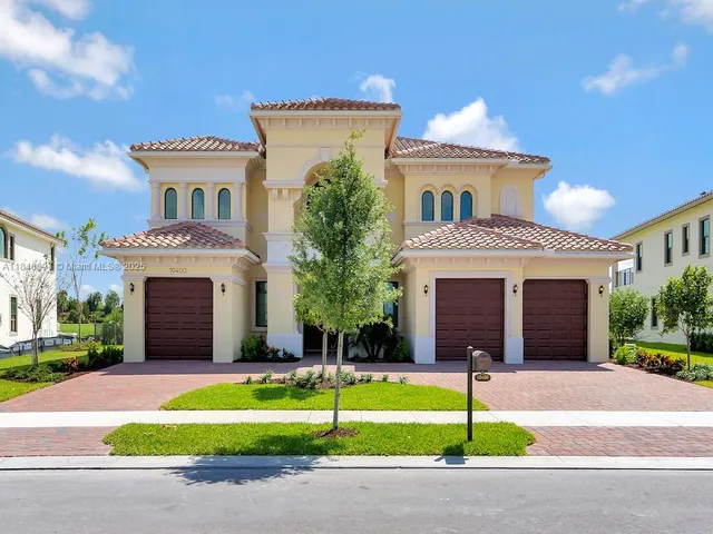 a front view of a house with a garden and yard