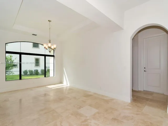a view of kitchen with stainless steel appliances refrigerator and window