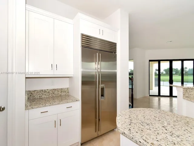 a bathroom with a granite countertop sink a toilet and bathtub