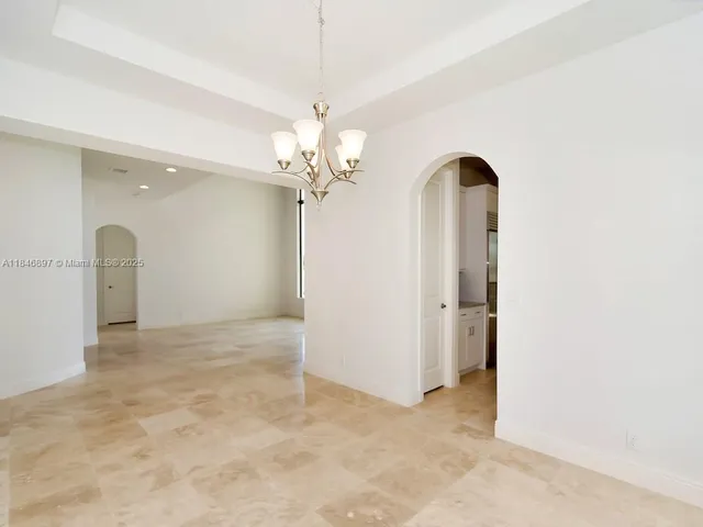 a picture of a room with a white wall and a window