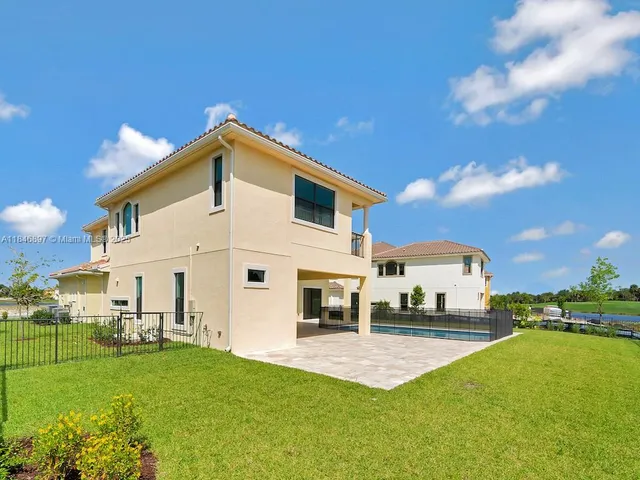 a view of a white house with a yard