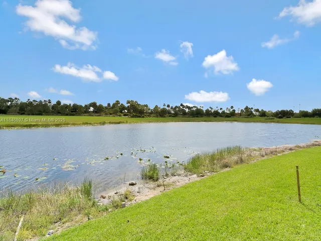 a view of a lake with houses in the back