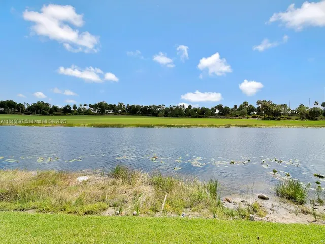 a view of a lake with houses in the back