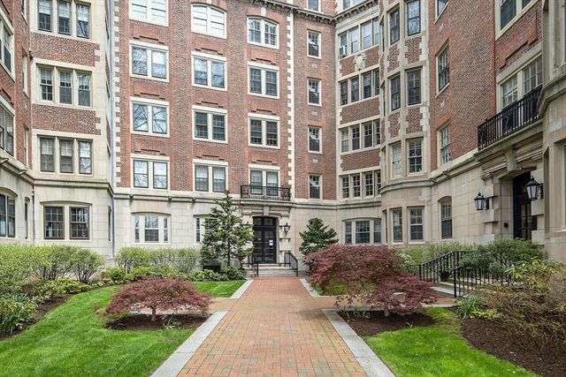 a view of a building next to a yard