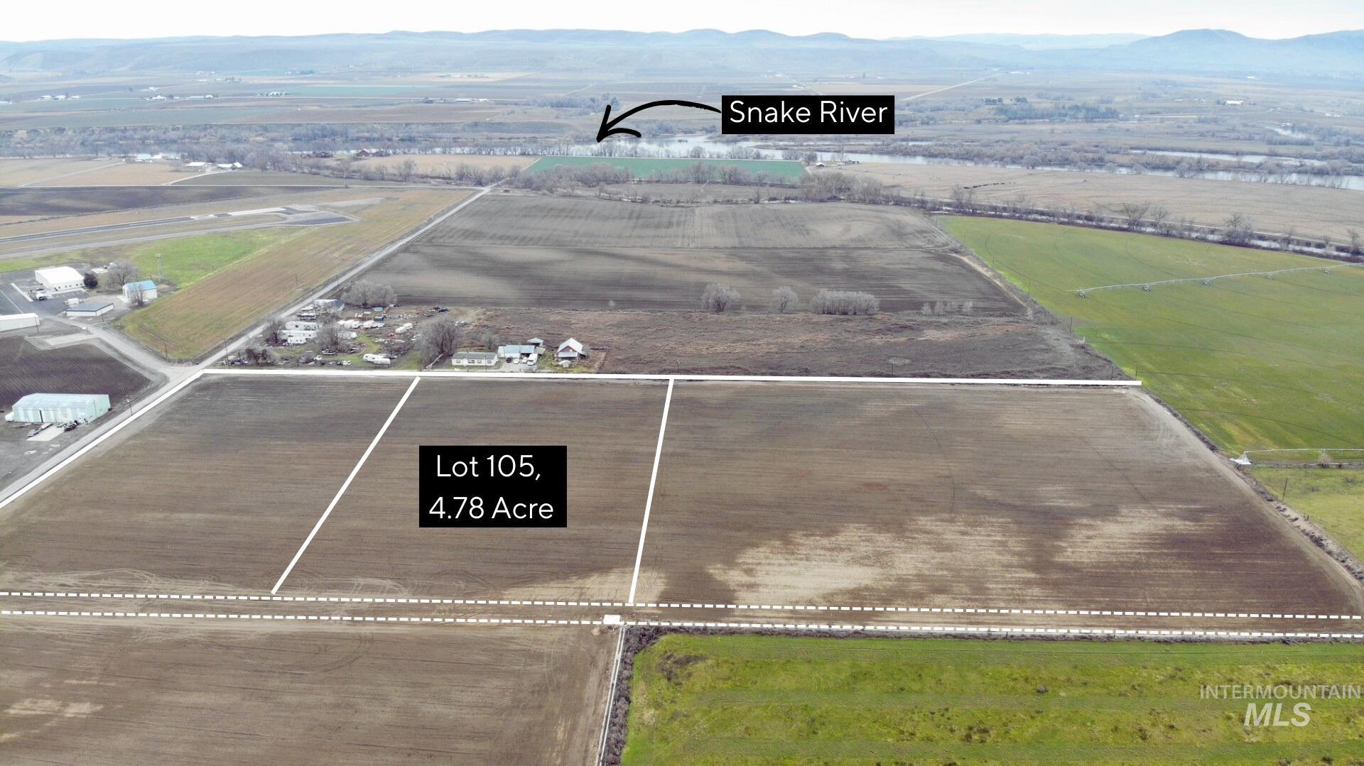 Tbd Tbd Delicious Street Weiser, ID 83672 - Photo 5 of 6 Aerial view of sparsely populated area featuring a mountainous background and rows of crops