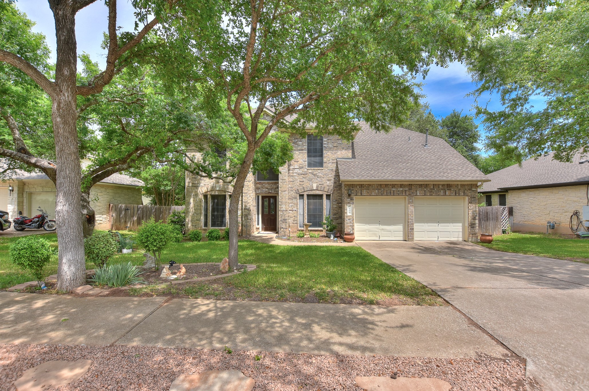 1609 Colton Way Cedar Park, TX 78613 - Photo 1 of 24 Mature trees frame this traditional brick home with a two-car garage and manicured front lawn.
