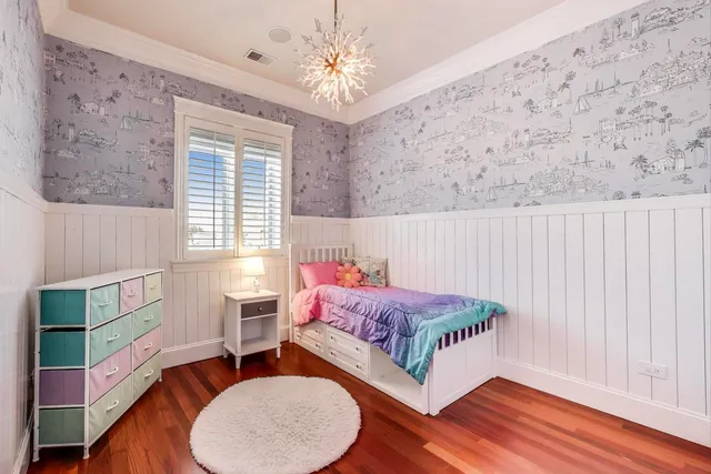 a bedroom with a bed mirror and a window