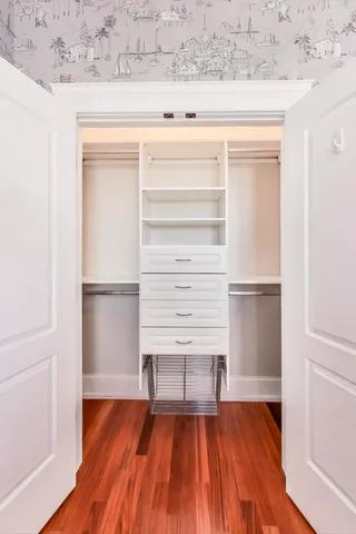 a view of walk in closet with empty racks