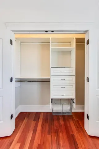 a view of walk in closet with empty racks