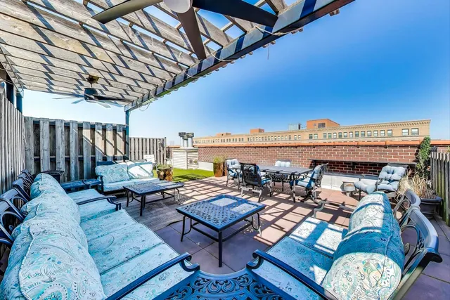 a living room with furniture and a floor to ceiling window