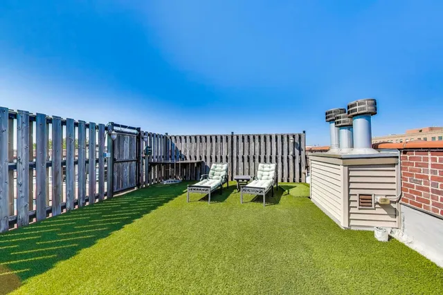 a view of a chair and table in the backyard