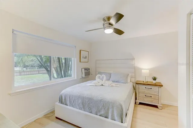 a bedroom with a large bed and a large window