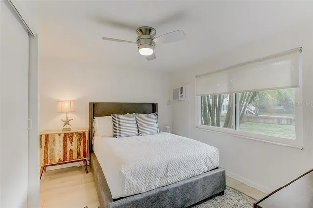 a bedroom with a large bed and a window