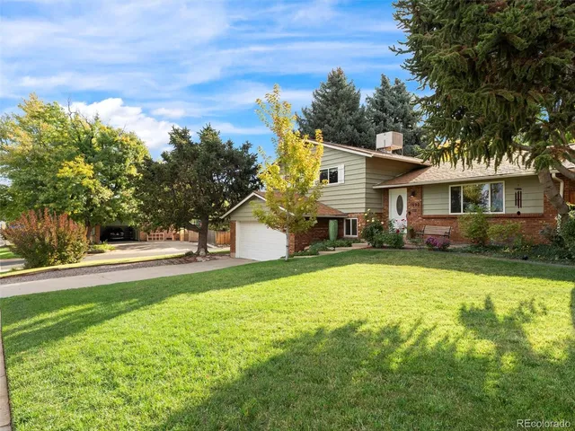 a front view of house with yard and trees