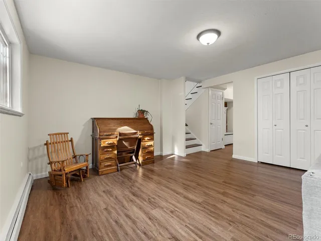 a view of a workspace with furniture and wooden floor