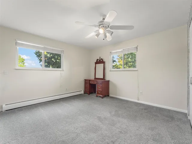 a view of a livingroom with a ceiling fan and window