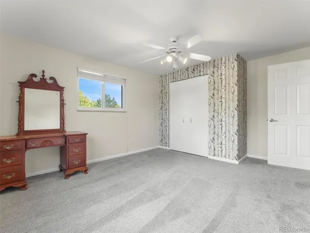 an empty room with windows and cabinet